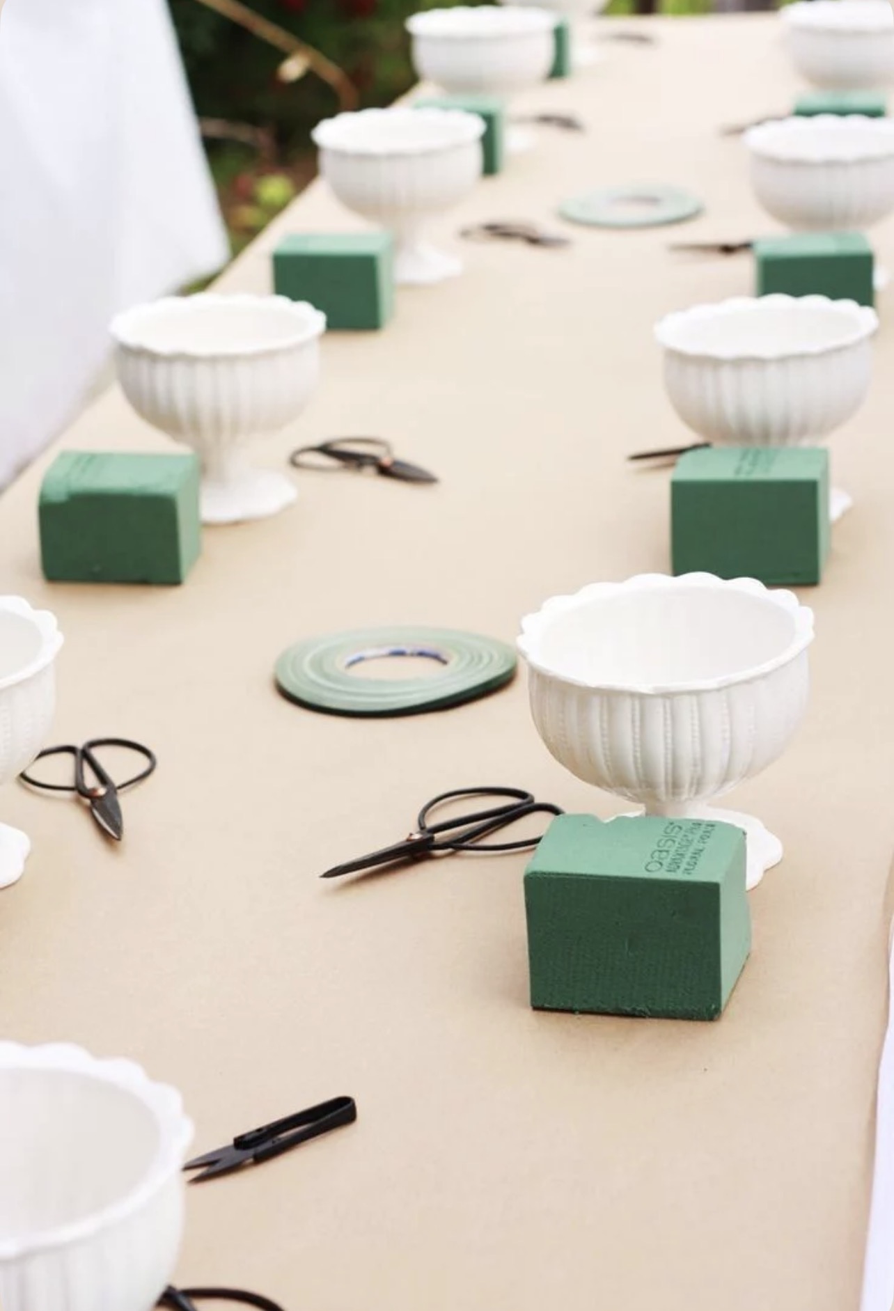 Workshop table set with compotes, oasis foam, and shears
